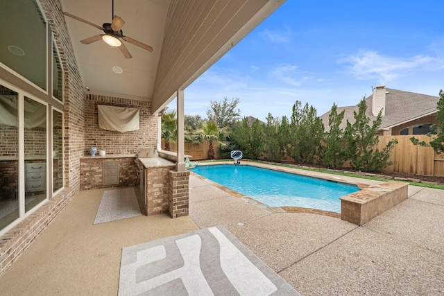 view of pool with a patio, area for grilling, and ceiling fan