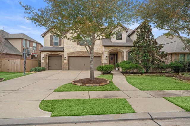 view of front of house with a garage and a front yard