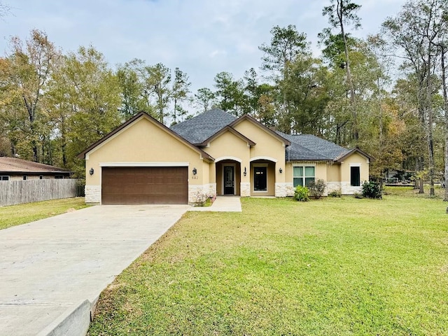 ranch-style house featuring a garage and a front lawn