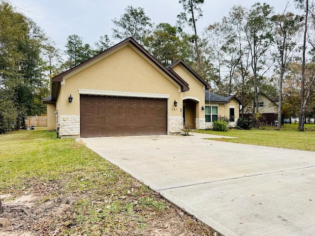 single story home with a garage and a front lawn