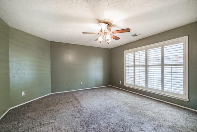 carpeted empty room with a textured ceiling and ceiling fan