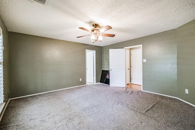 carpeted empty room with a textured ceiling and ceiling fan