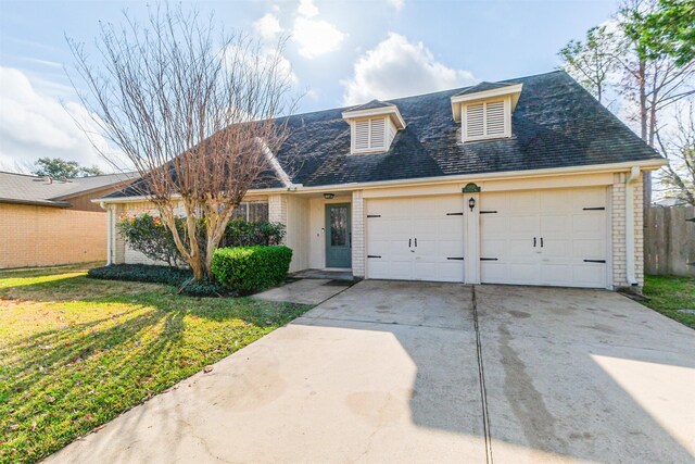 view of front of home with a garage and a front yard