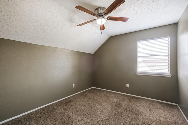 additional living space with ceiling fan, lofted ceiling, carpet floors, and a textured ceiling