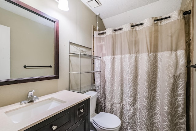 bathroom featuring vaulted ceiling, curtained shower, vanity, toilet, and a textured ceiling