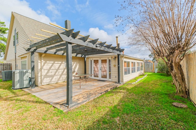 back of property with french doors, central AC, a lawn, and a pergola