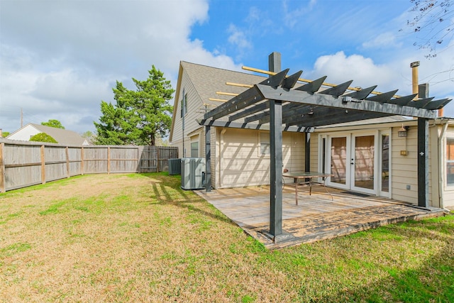 rear view of property with central AC unit, a pergola, a lawn, and french doors