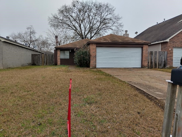 ranch-style home featuring a garage and a front yard