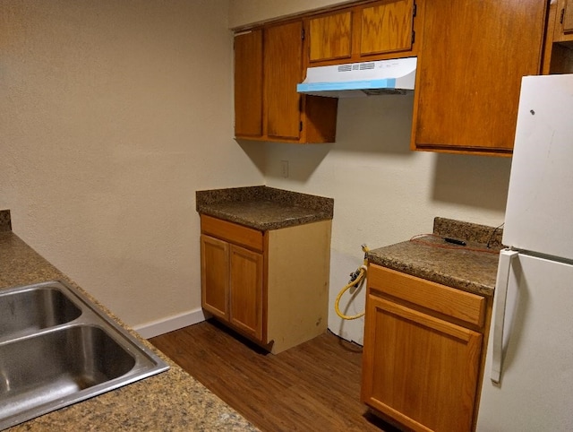 kitchen featuring white fridge, sink, and dark hardwood / wood-style flooring