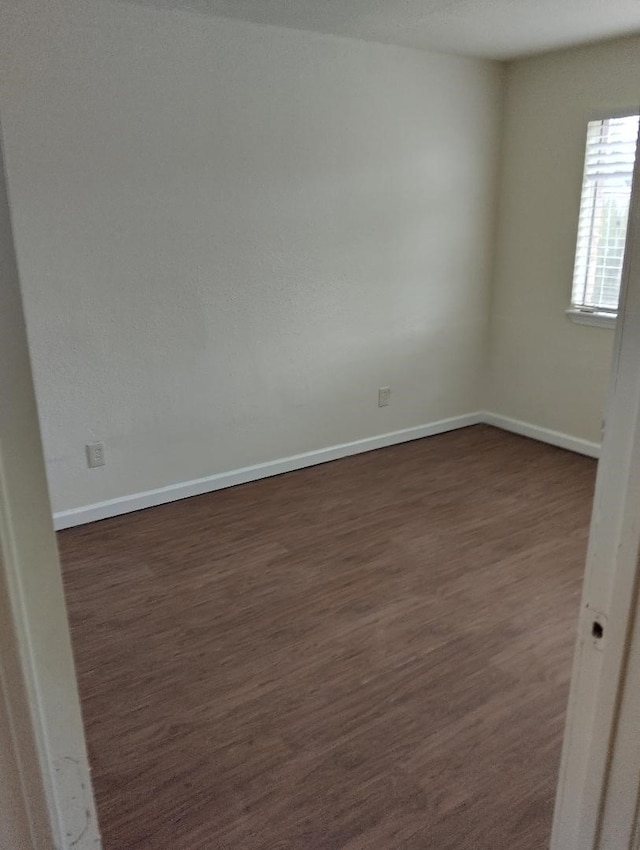 spare room featuring dark hardwood / wood-style floors