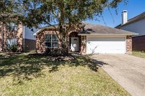 view of front of house featuring a garage and a front lawn