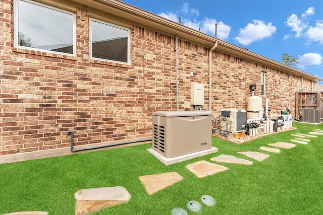 rear view of property featuring a yard and central AC unit