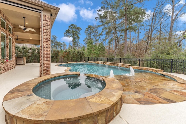 view of pool featuring an in ground hot tub, pool water feature, ceiling fan, and a patio