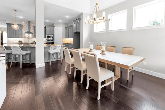 dining space featuring a notable chandelier and dark hardwood / wood-style floors