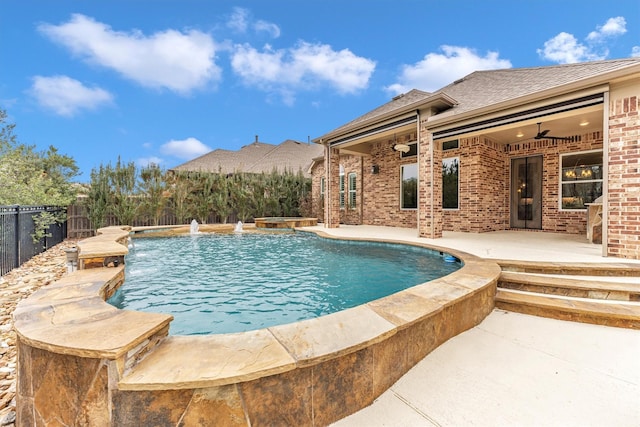 view of swimming pool featuring pool water feature, ceiling fan, and a patio area