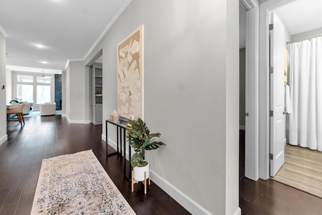 hall with ornamental molding and dark hardwood / wood-style flooring