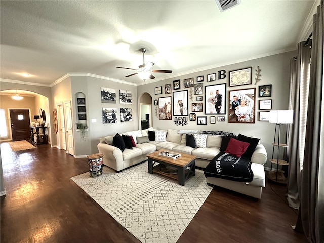 living room featuring ceiling fan, hardwood / wood-style flooring, ornamental molding, and a textured ceiling