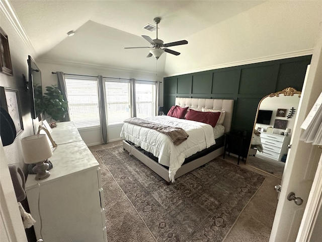 bedroom with dark colored carpet, lofted ceiling, ornamental molding, and ceiling fan