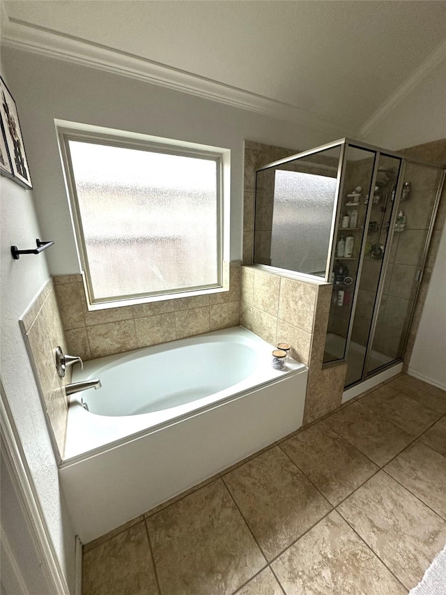 bathroom featuring independent shower and bath, ornamental molding, and tile patterned floors