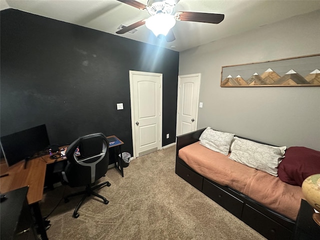 carpeted office featuring ceiling fan