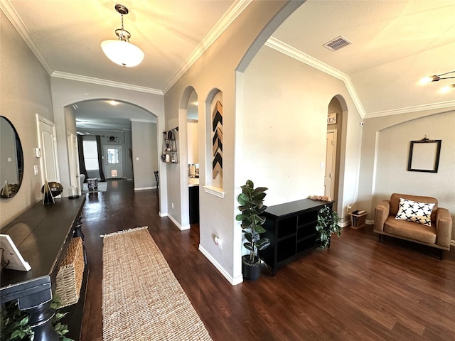 entryway featuring lofted ceiling, ornamental molding, and dark hardwood / wood-style flooring