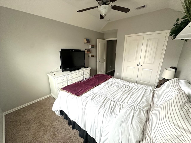 carpeted bedroom featuring vaulted ceiling, a closet, and ceiling fan