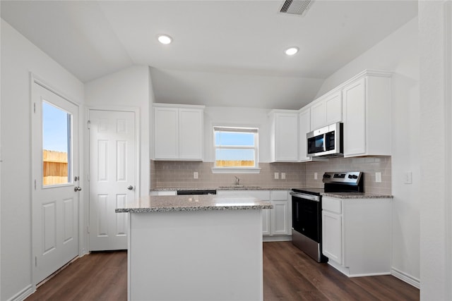 kitchen with white cabinetry, lofted ceiling, and appliances with stainless steel finishes