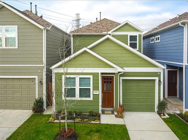 view of front of house with a garage and a front lawn