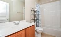 full bathroom featuring shower / tub combo, vanity, tile patterned floors, and toilet