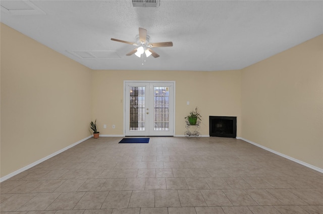 unfurnished living room featuring french doors, ceiling fan, and light tile patterned flooring