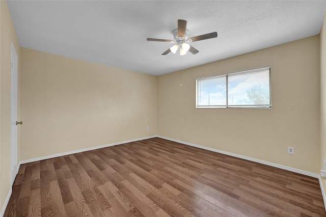 empty room with a textured ceiling, wood-type flooring, and ceiling fan