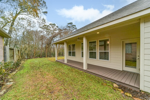 view of yard featuring a wooden deck and ceiling fan