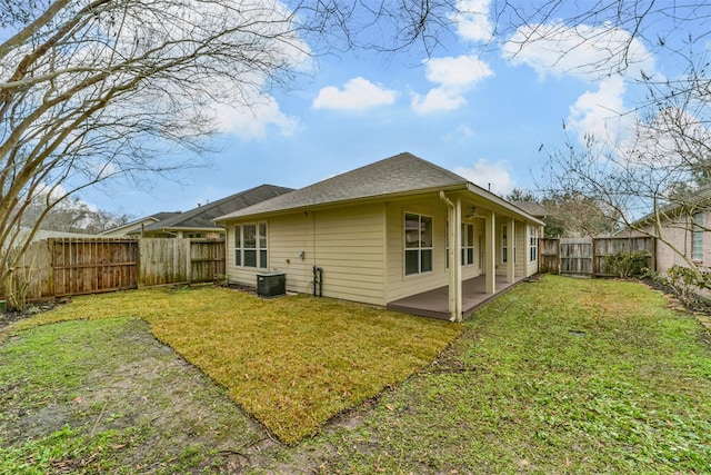 back of house with a yard and a patio area