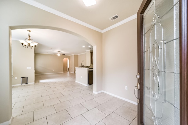 foyer entrance featuring ornamental molding, sink, ceiling fan with notable chandelier, and light tile patterned floors