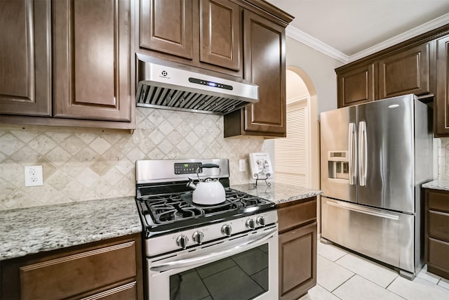 kitchen with light stone counters, ornamental molding, appliances with stainless steel finishes, and range hood