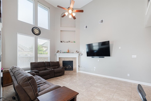 living room with light tile patterned flooring, a towering ceiling, and ceiling fan