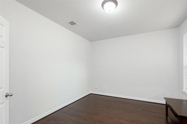 unfurnished room featuring dark wood-type flooring