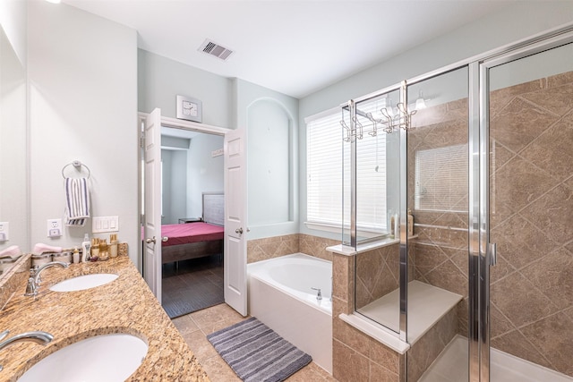 bathroom featuring independent shower and bath, vanity, and tile patterned floors