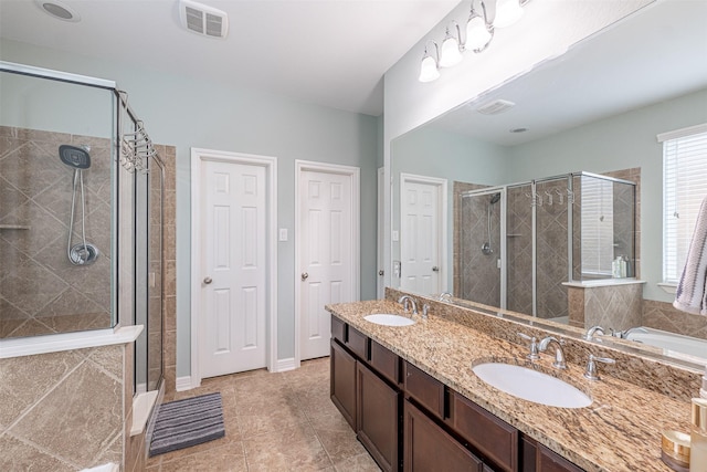 bathroom with vanity, tile patterned flooring, and a shower with door