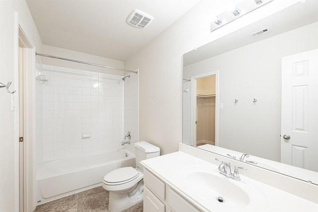 full bathroom featuring tiled shower / bath, vanity, and toilet