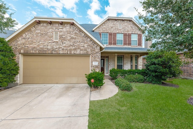 view of front of property with a garage, a porch, and a front yard