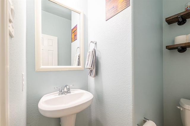 bathroom featuring sink and toilet