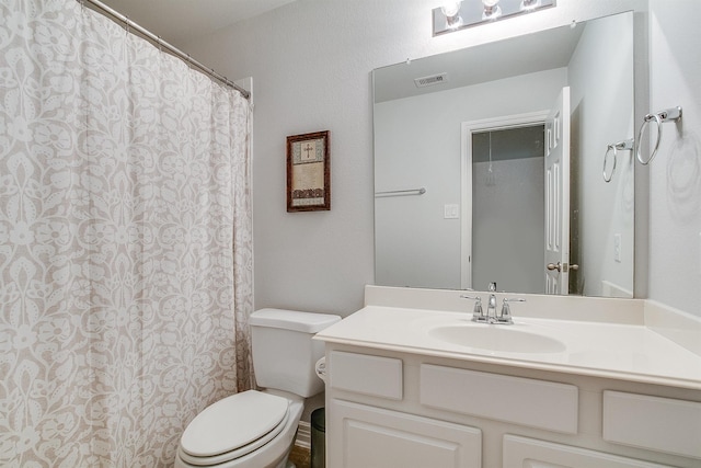 bathroom with vanity, a shower with curtain, and toilet