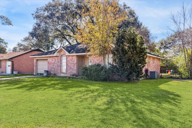 view of front of property with cooling unit, a garage, and a front yard