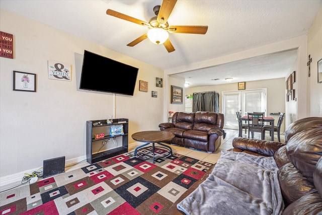 living room featuring light tile patterned flooring and ceiling fan