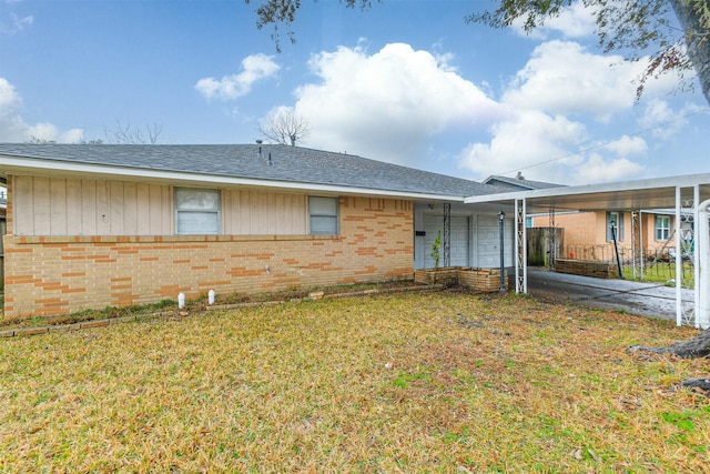 single story home with a carport and a front lawn