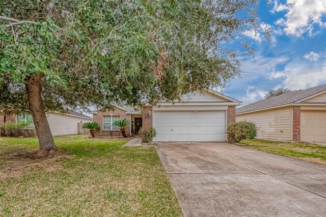 view of front of home featuring a garage and a front yard