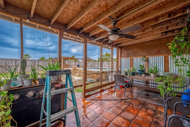 sunroom featuring ceiling fan