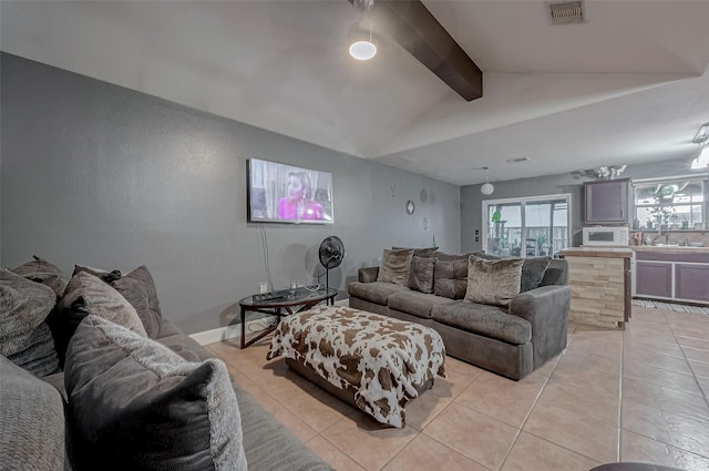 living room featuring light tile patterned flooring and vaulted ceiling with beams