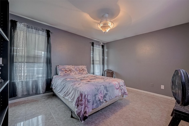 bedroom with light tile patterned flooring and ceiling fan